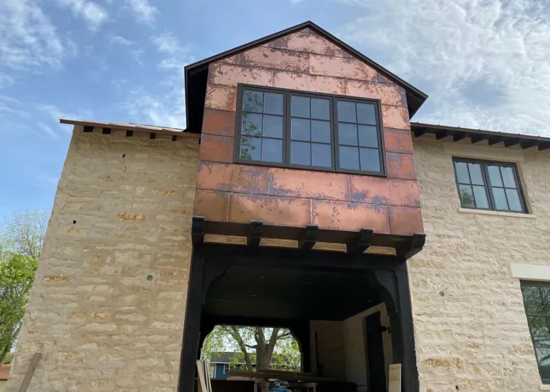 Copper metal panel facade on a stone building for Skylight Installation in Holly Springs