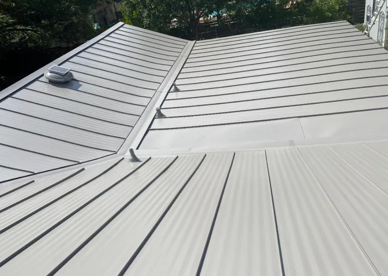 Solar attic fan installed on a metal roof for Roof Ventilation in Holly Springs